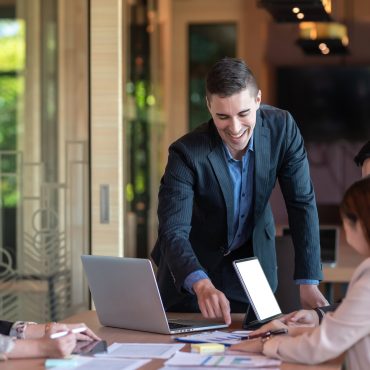 Group of business people investment advisors analyzing financial report in meeting.